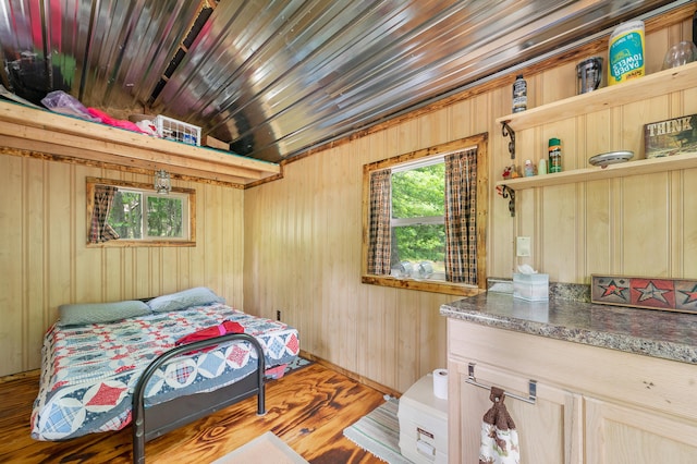 122 Canyon Rd, Leroy, MI 49655 - bedroom featuring wooden walls and wood finished floors