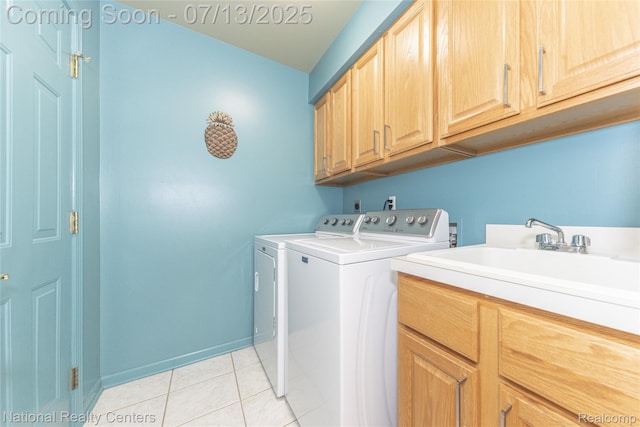 285 Ash Ct, South Lyon, MI 48178 - laundry area featuring cabinet space, washing machine and dryer, and light tile patterned floors