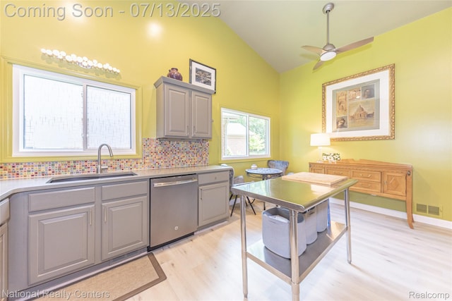 285 Ash Ct, South Lyon, MI 48178 - kitchen with dishwasher, gray cabinets, vaulted ceiling, light wood-type flooring, and decorative backsplash