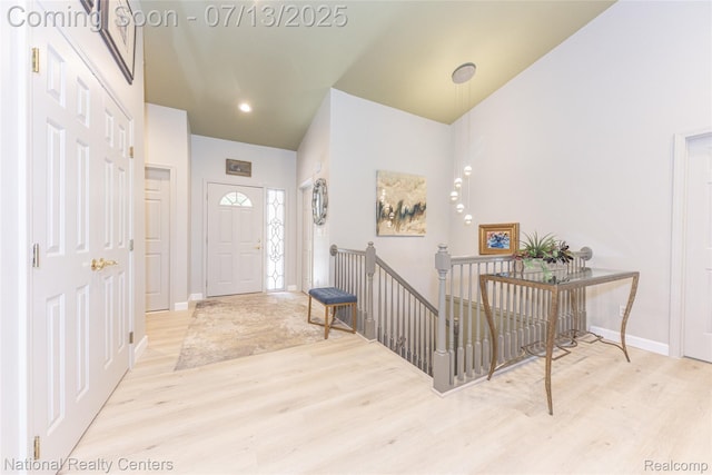 285 Ash Ct, South Lyon, MI 48178 - entrance foyer featuring wood finished floors and a towering ceiling
