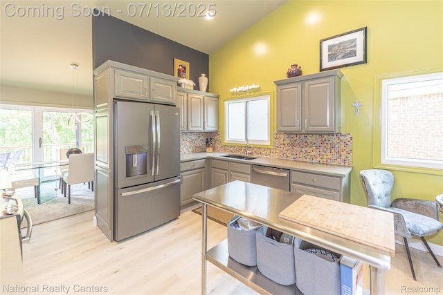 285 Ash Ct, South Lyon, MI 48178 - kitchen featuring appliances with stainless steel finishes, gray cabinets, light wood-style flooring, tasteful backsplash, and light countertops