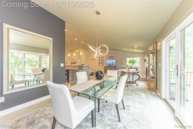 285 Ash Ct, South Lyon, MI 48178 - dining area featuring light wood-style flooring, a chandelier, recessed lighting, and lofted ceiling