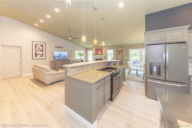 285 Ash Ct, South Lyon, MI 48178 - kitchen featuring stainless steel refrigerator with ice dispenser, range with electric cooktop, light wood finished floors, a fireplace, and recessed lighting