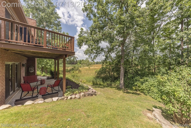 285 Ash Ct, South Lyon, MI 48178 - view of grassy yard featuring a deck and a patio
