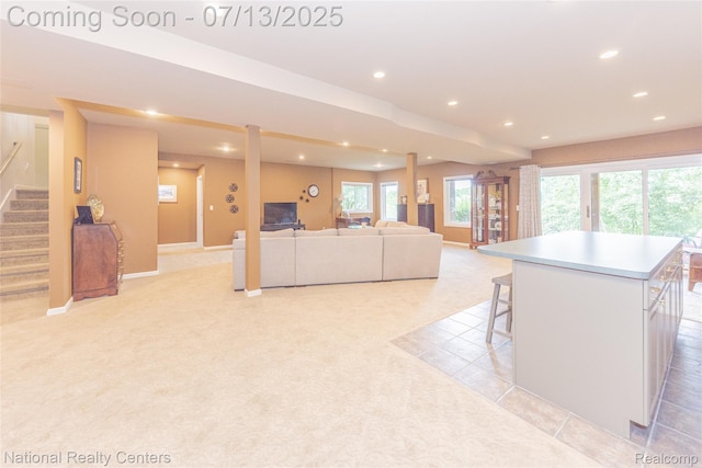 285 Ash Ct, South Lyon, MI 48178 - living area with recessed lighting, light colored carpet, and stairway