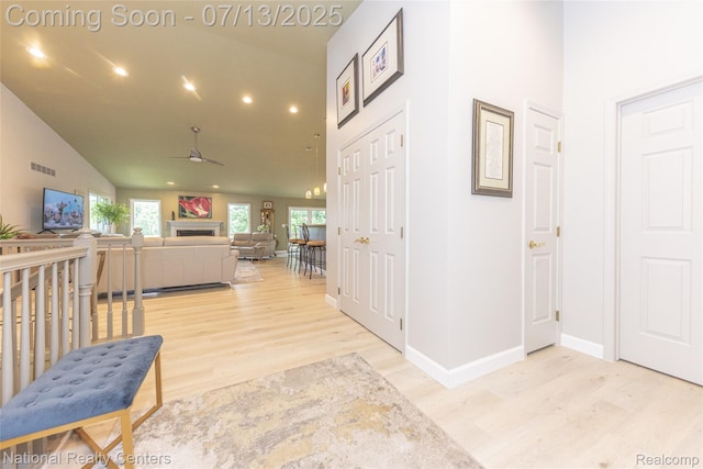 285 Ash Ct, South Lyon, MI 48178 - hall with light wood-type flooring, high vaulted ceiling, and recessed lighting