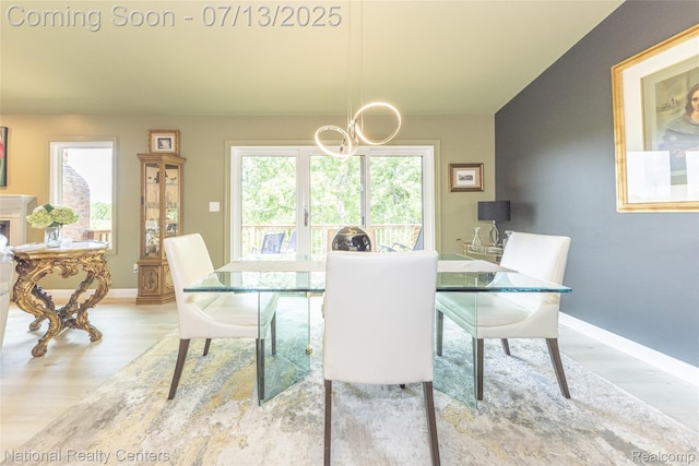 285 Ash Ct, South Lyon, MI 48178 - dining area featuring a chandelier and wood finished floors