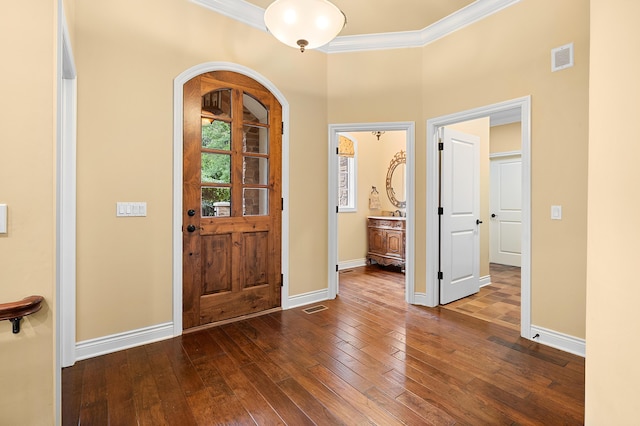 1431 Edgemoor Ave, Kalamazoo, MI 49008 - foyer with crown molding, dark wood finished floors, and arched walkways