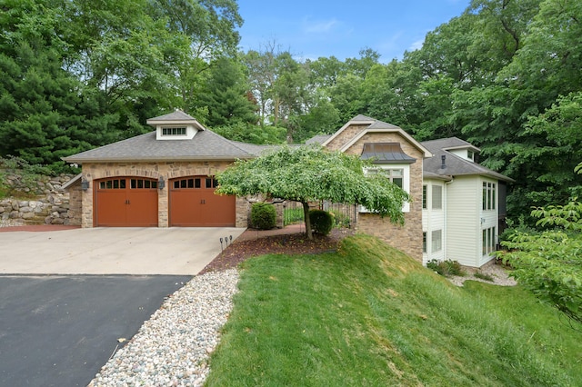 1431 Edgemoor Ave, Kalamazoo, MI 49008 - view of front facade with driveway, stone siding, a shingled roof, a front lawn, and a garage