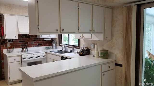 5396 Provincial Dr, Bloomfield Hills, MI 48302 - kitchen with white range with electric cooktop, light countertops, a peninsula, and white cabinetry