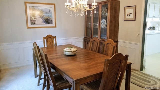 5396 Provincial Dr, Bloomfield Hills, MI 48302 - dining room featuring a chandelier, a decorative wall, and a wainscoted wall