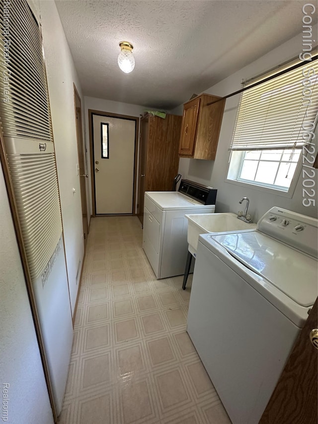 8049 Mckinley Rd, Clay, MI 48001 - laundry room with a heating unit, cabinet space, light flooring, washer and clothes dryer, and a textured ceiling