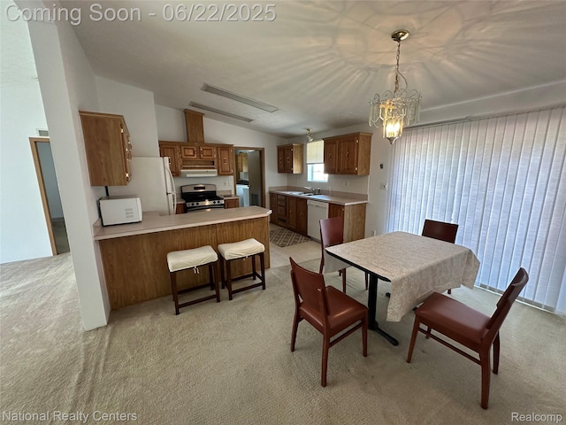 8049 Mckinley Rd, Clay, MI 48001 - dining area featuring light colored carpet, washer / clothes dryer, vaulted ceiling, and a chandelier