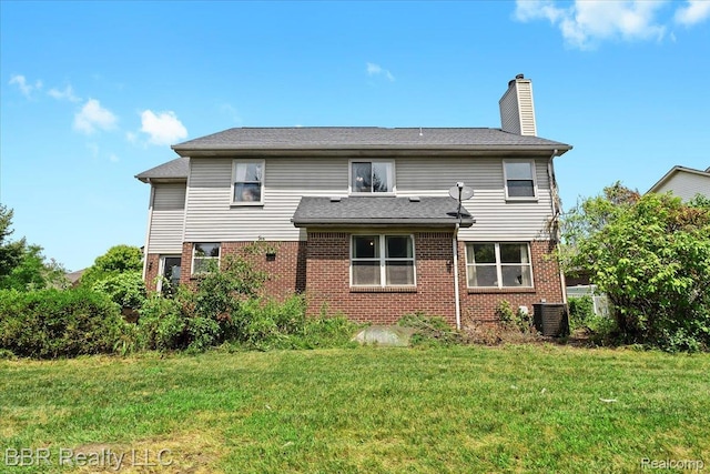 20077 Dovetail Dr, Brownstown, MI 48183 - rear view of property with brick siding, a chimney, and a lawn
