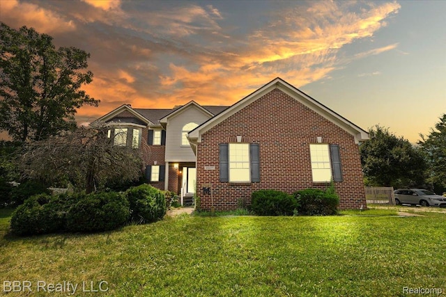 20077 Dovetail Dr, Brownstown, MI 48183 - traditional-style house with a yard and brick siding