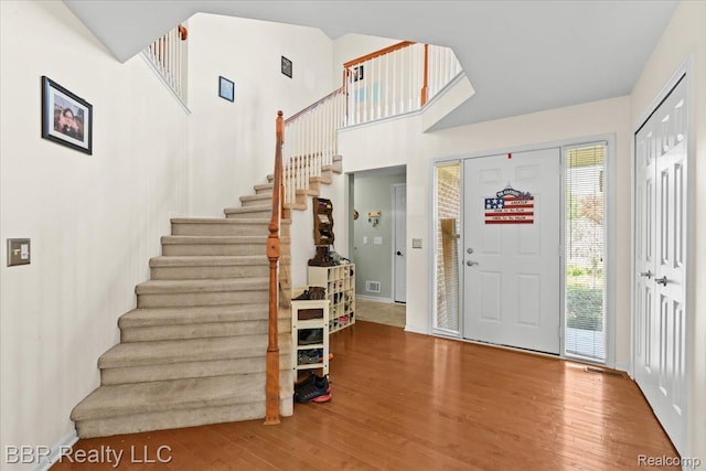 20077 Dovetail Dr, Brownstown, MI 48183 - entrance foyer with stairs, wood finished floors, and a high ceiling