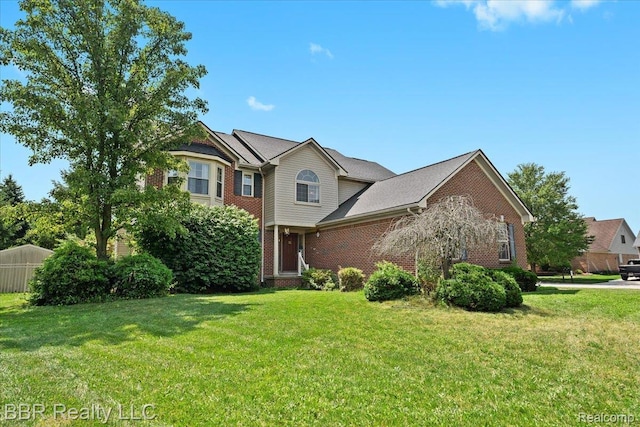 20077 Dovetail Dr, Brownstown, MI 48183 - traditional home with brick siding and a front lawn