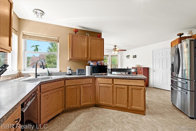 20077 Dovetail Dr, Brownstown, MI 48183 - kitchen featuring stainless steel appliances, a peninsula, and brown cabinetry