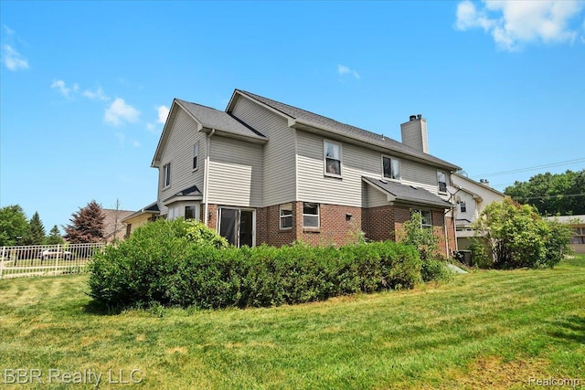 20077 Dovetail Dr, Brownstown, MI 48183 - rear view of property with brick siding and a chimney