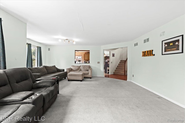 20077 Dovetail Dr, Brownstown, MI 48183 - carpeted living area with stairs and baseboards