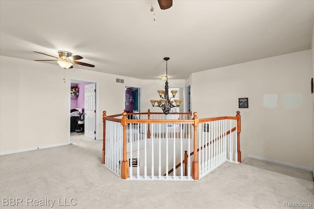 20077 Dovetail Dr, Brownstown, MI 48183 - hall featuring an upstairs landing, carpet floors, and a chandelier