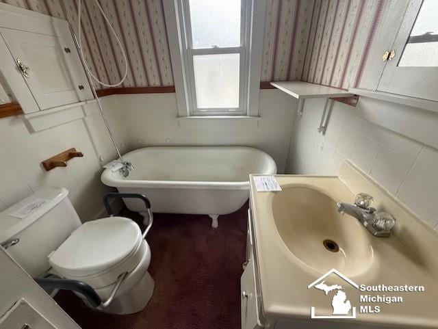 211 Huber Dr, Monroe, MI 48162 - bathroom with a freestanding bath, vanity, and wallpapered walls