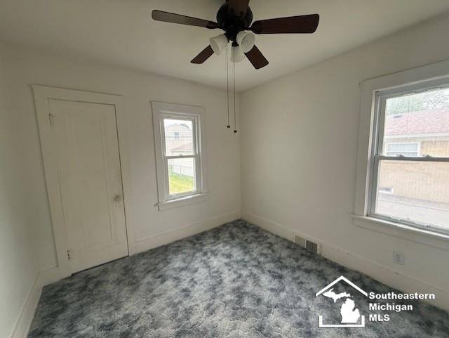 211 Huber Dr, Monroe, MI 48162 - carpeted empty room with healthy amount of natural light and a ceiling fan
