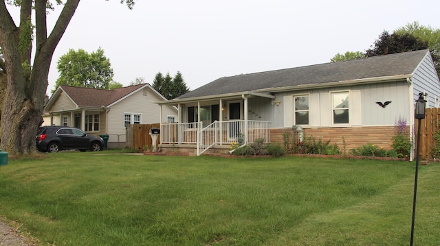 9262 Washington St, Romulus, MI 48174 - ranch-style home featuring covered porch, a front yard, board and batten siding, and a shingled roof