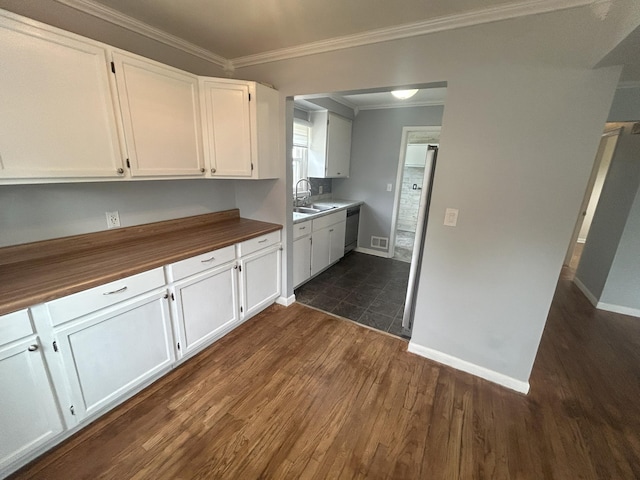 9262 Washington St, Romulus, MI 48174 - kitchen featuring dark wood-style flooring, white cabinets, wooden counters, stainless steel dishwasher, and crown molding