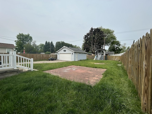 9262 Washington St, Romulus, MI 48174 - fenced backyard with a detached garage, an outdoor structure, and a playground