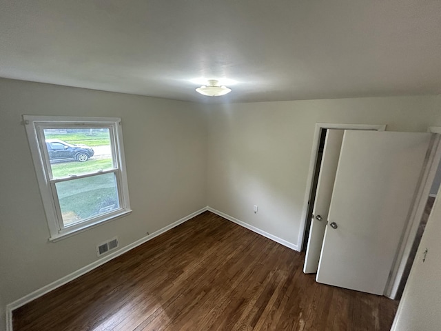 9262 Washington St, Romulus, MI 48174 - unfurnished bedroom featuring dark wood-type flooring and a closet