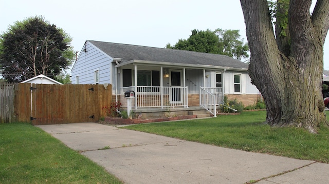 9262 Washington St, Romulus, MI 48174 - ranch-style home with covered porch, roof with shingles, board and batten siding, and a gate