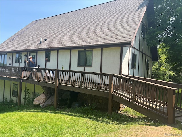5636 Crescent St, Norway, MI 49870 - rear view of house featuring a shingled roof, a deck, and a lawn