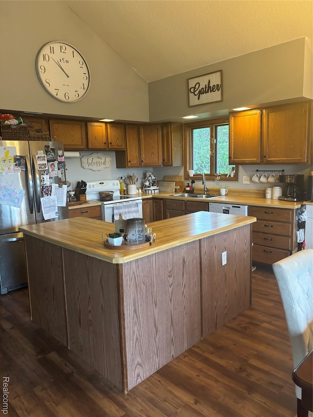 5636 Crescent St, Norway, MI 49870 - kitchen featuring white electric range oven, freestanding refrigerator, a center island, dark wood-style flooring, and high vaulted ceiling