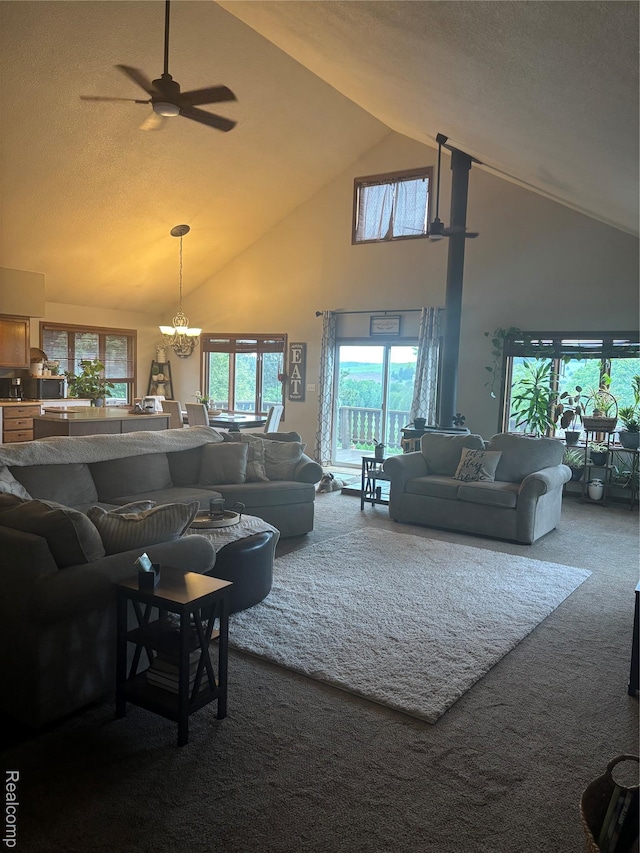 5636 Crescent St, Norway, MI 49870 - living room featuring high vaulted ceiling, dark colored carpet, a ceiling fan, and a chandelier