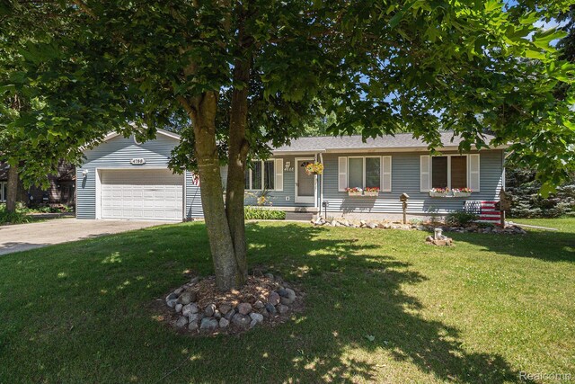 4788 Apache Trl, Columbiaville, MI 48421 - view of front of house featuring a garage, a front yard, and driveway