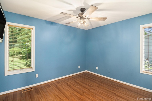 4788 Apache Trl, Columbiaville, MI 48421 - unfurnished room featuring healthy amount of natural light, wood finished floors, and a ceiling fan