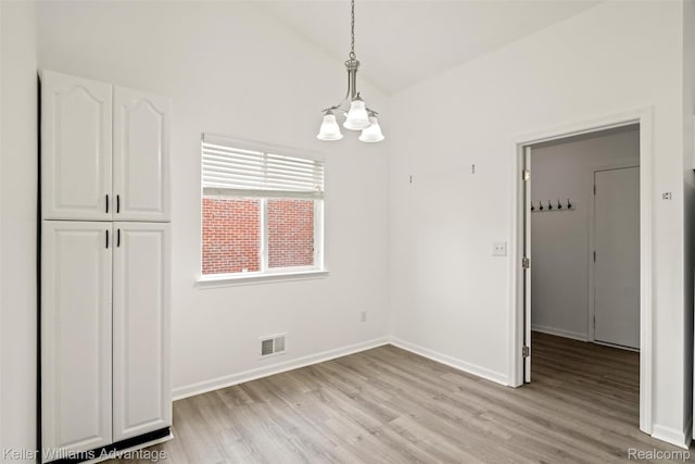 41215 Westfield Cir, Canton, MI 48188 - unfurnished dining area featuring light wood-style floors, a chandelier, and vaulted ceiling