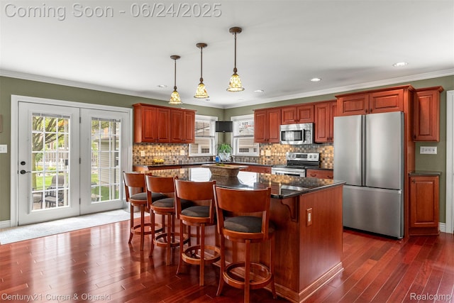 15275 Belmont Ave, Allen Park, MI 48101 - kitchen featuring stainless steel appliances, dark wood-style flooring, ornamental molding, decorative backsplash, and a kitchen island