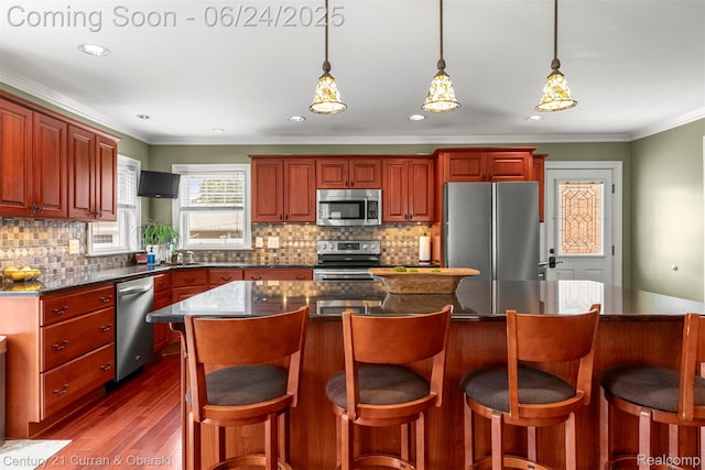 15275 Belmont Ave, Allen Park, MI 48101 - kitchen with appliances with stainless steel finishes, dark wood-type flooring, tasteful backsplash, dark countertops, and crown molding