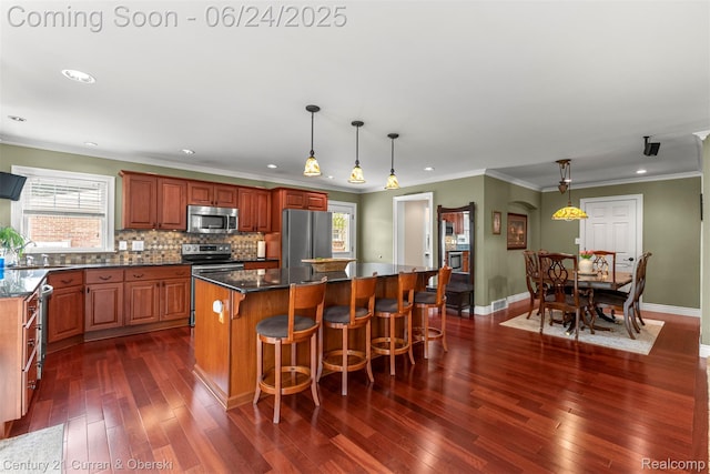 15275 Belmont Ave, Allen Park, MI 48101 - kitchen featuring appliances with stainless steel finishes, dark wood finished floors, recessed lighting, a kitchen island, and backsplash