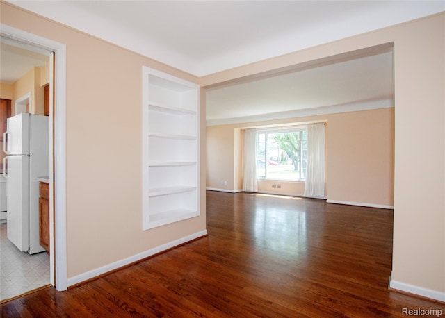 16555 Juliana Ave, Eastpointe, MI 48021 - spare room featuring built in features and wood finished floors