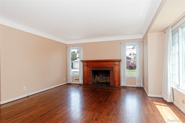 16555 Juliana Ave, Eastpointe, MI 48021 - unfurnished living room featuring plenty of natural light, wood finished floors, and a brick fireplace