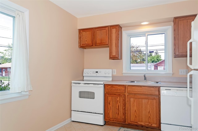 16555 Juliana Ave, Eastpointe, MI 48021 - kitchen featuring white appliances, light countertops, and brown cabinets