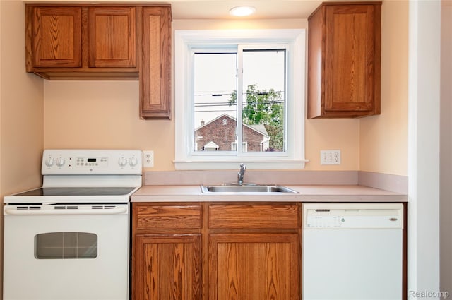 16555 Juliana Ave, Eastpointe, MI 48021 - kitchen with white appliances, light countertops, and brown cabinetry