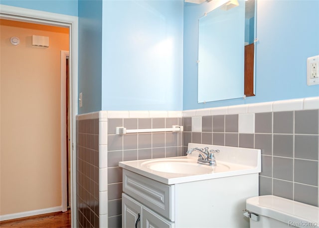 16555 Juliana Ave, Eastpointe, MI 48021 - half bath with tile walls, vanity, wainscoting, and wood finished floors