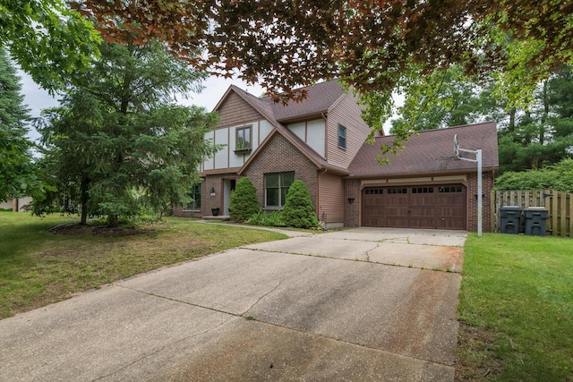 6615 Pleasantview Dr, Portage, MI 49024 - tudor home featuring an attached garage, driveway, brick siding, and roof with shingles