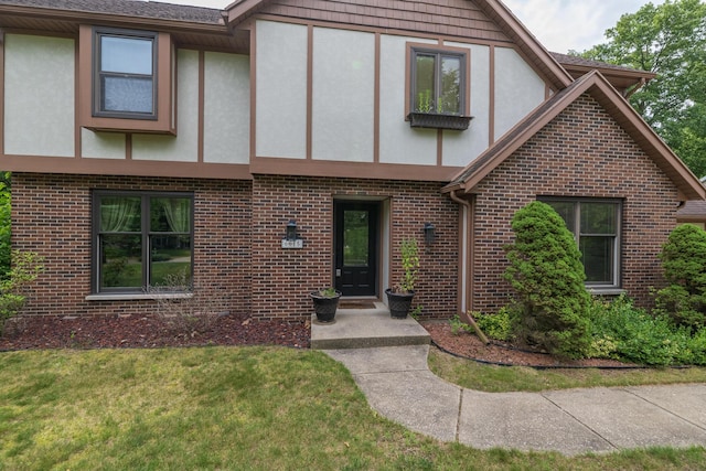 6615 Pleasantview Dr, Portage, MI 49024 - english style home with stucco siding, brick siding, and a front yard