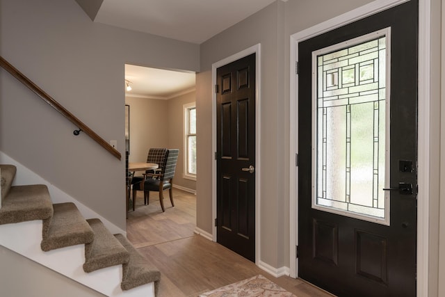 6615 Pleasantview Dr, Portage, MI 49024 - foyer featuring stairs, light wood-type flooring, and crown molding
