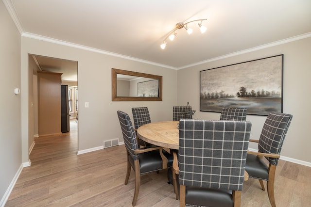 6615 Pleasantview Dr, Portage, MI 49024 - dining space with light wood-style flooring and crown molding